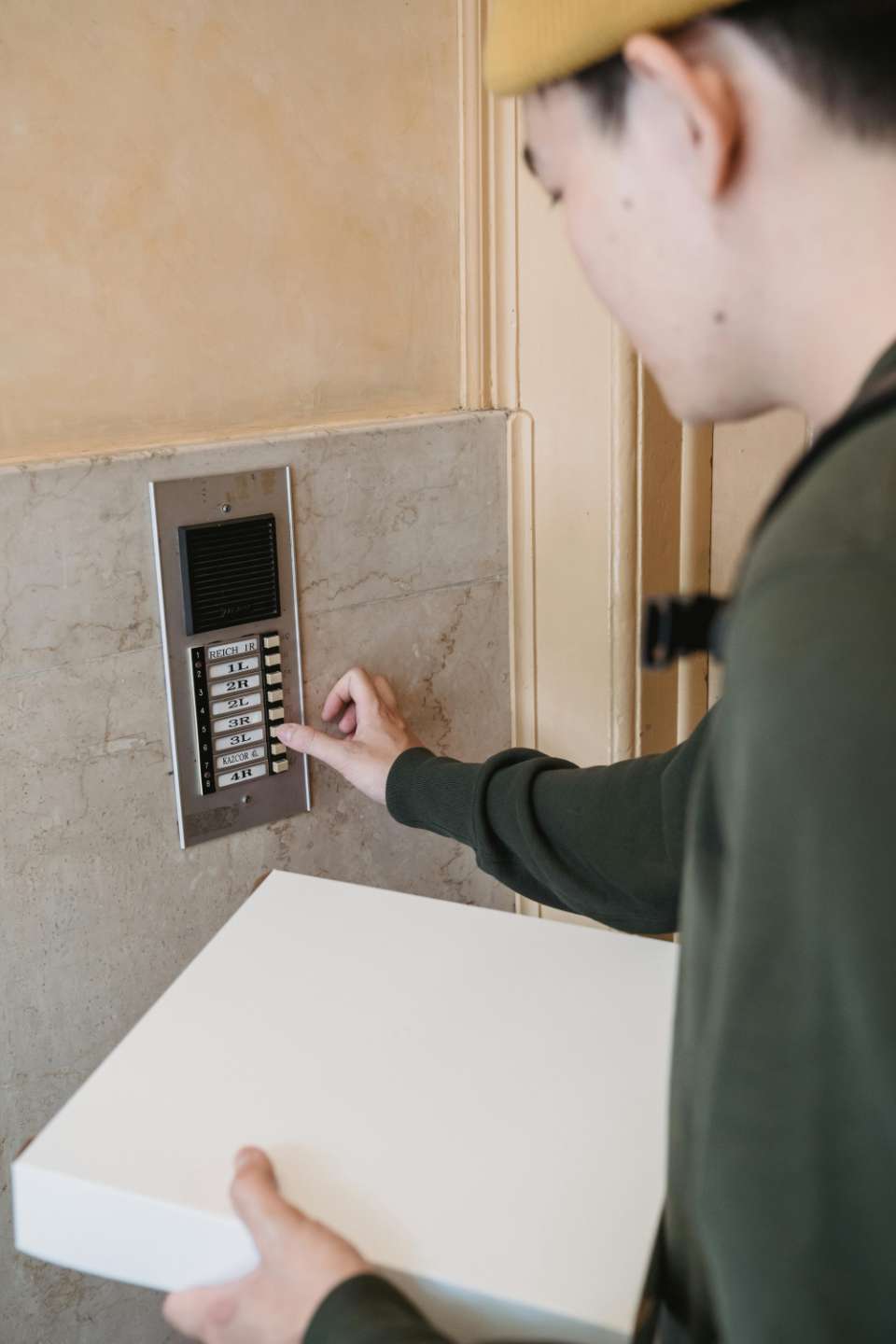 A person uses a fingerprint scanner for secure entry in a business setting.